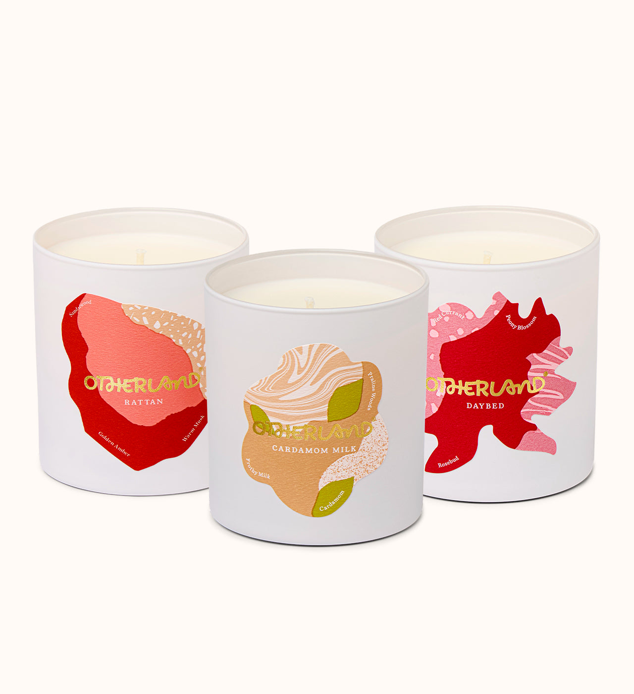 Three scented candles with colorful labels on a white background