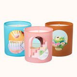 Three colorful candles with decorative lids on a white background