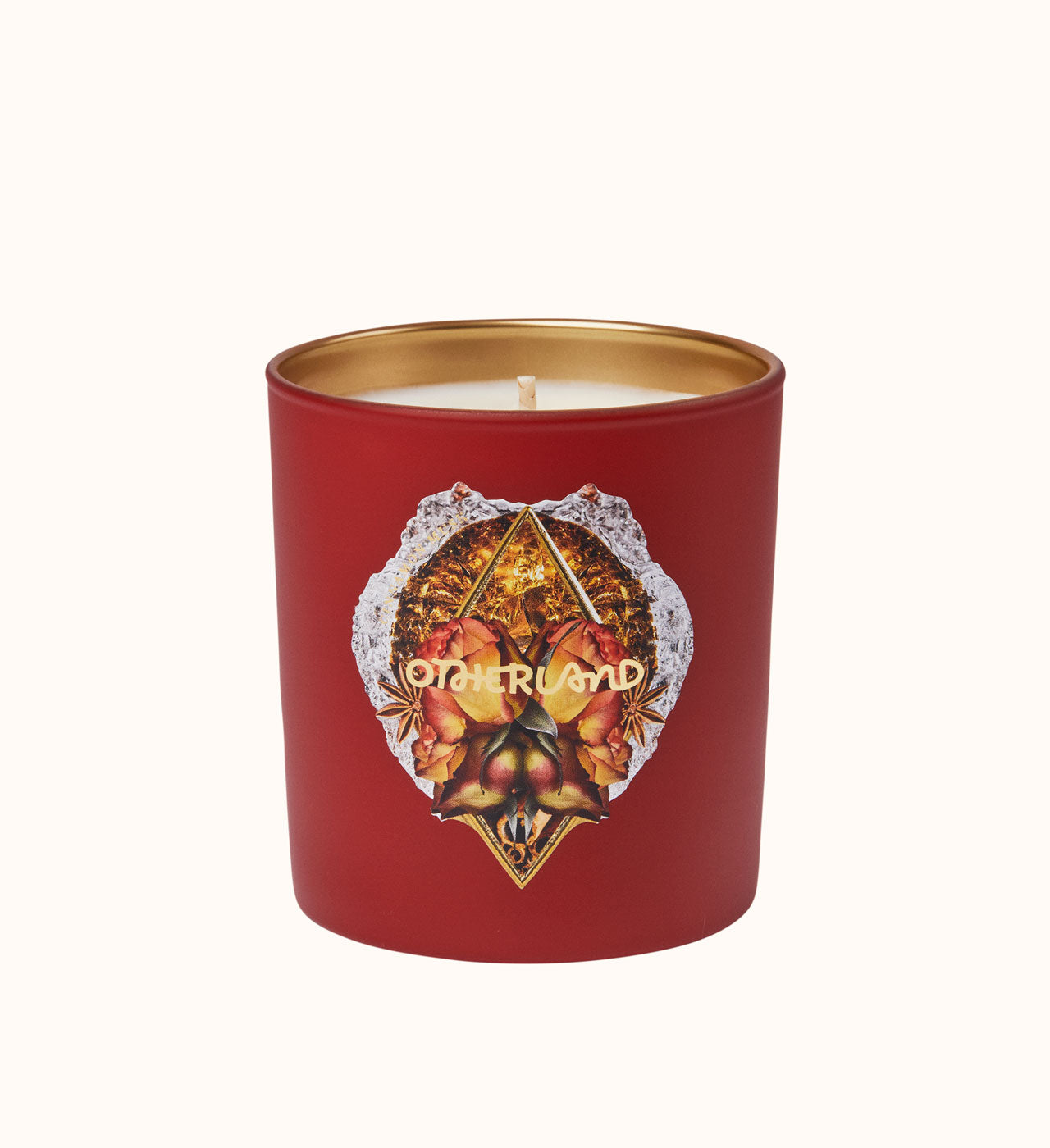 Red candle with gold lid and decorative label on a white background