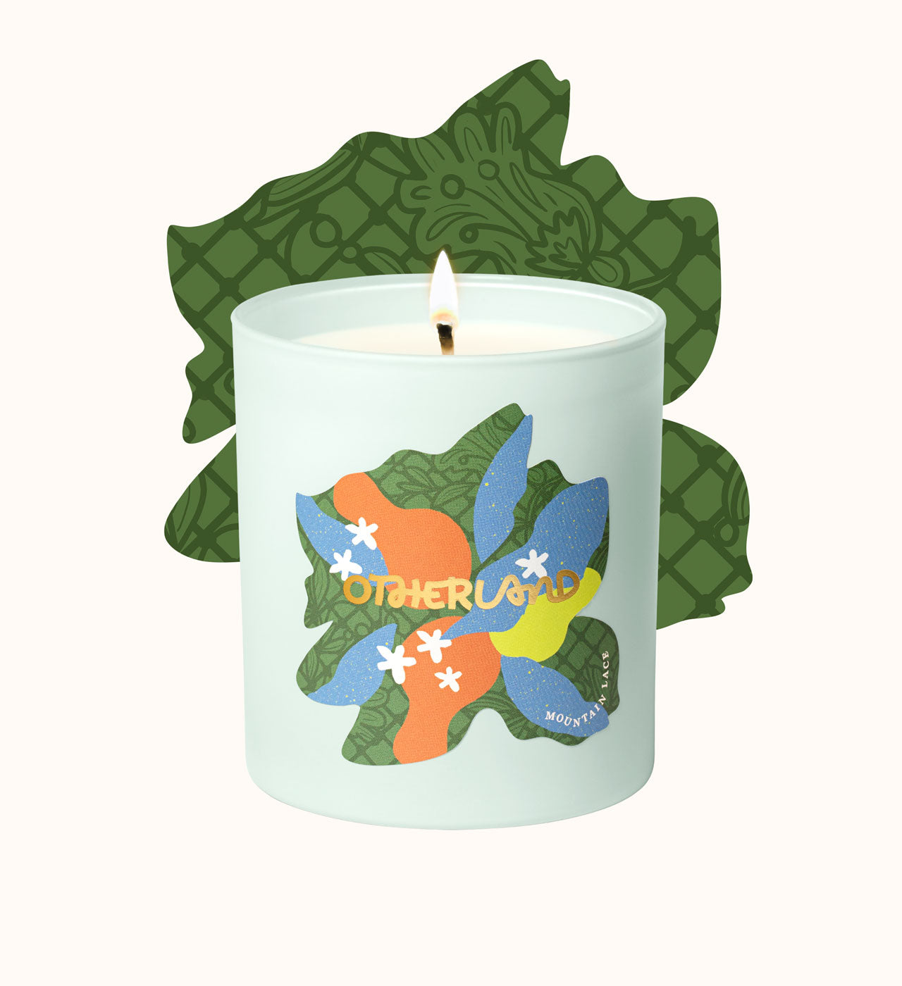 Candle with colorful leaf design and 'Otherland' branding on a white background