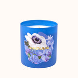 Blue candle with floral design and 'Otherland' branding on a white background