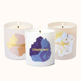 Three candles with colorful labels on a white background
