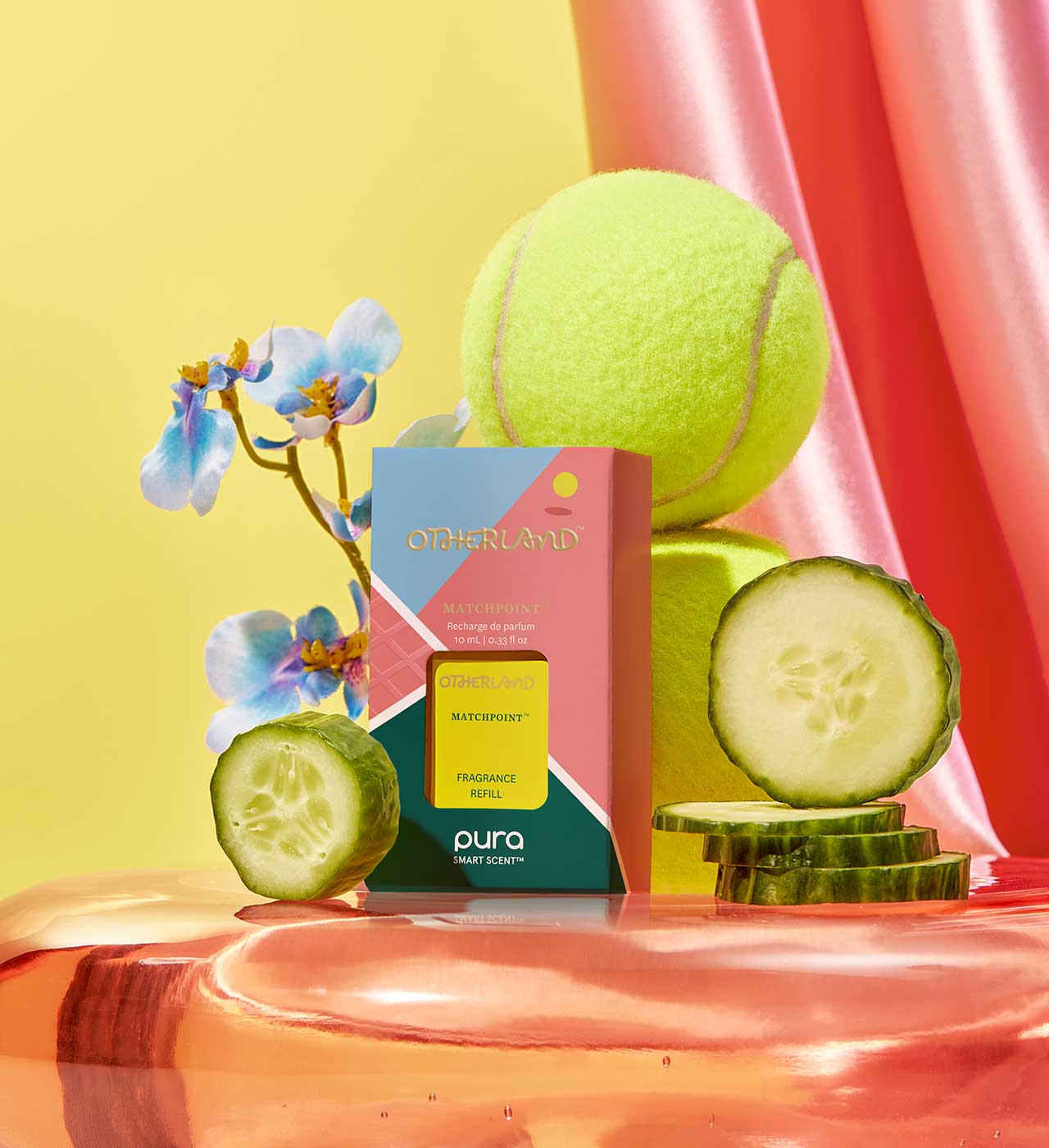 Pura refill product with a tennis ball, cucumber slices, and flowers on a colorful background