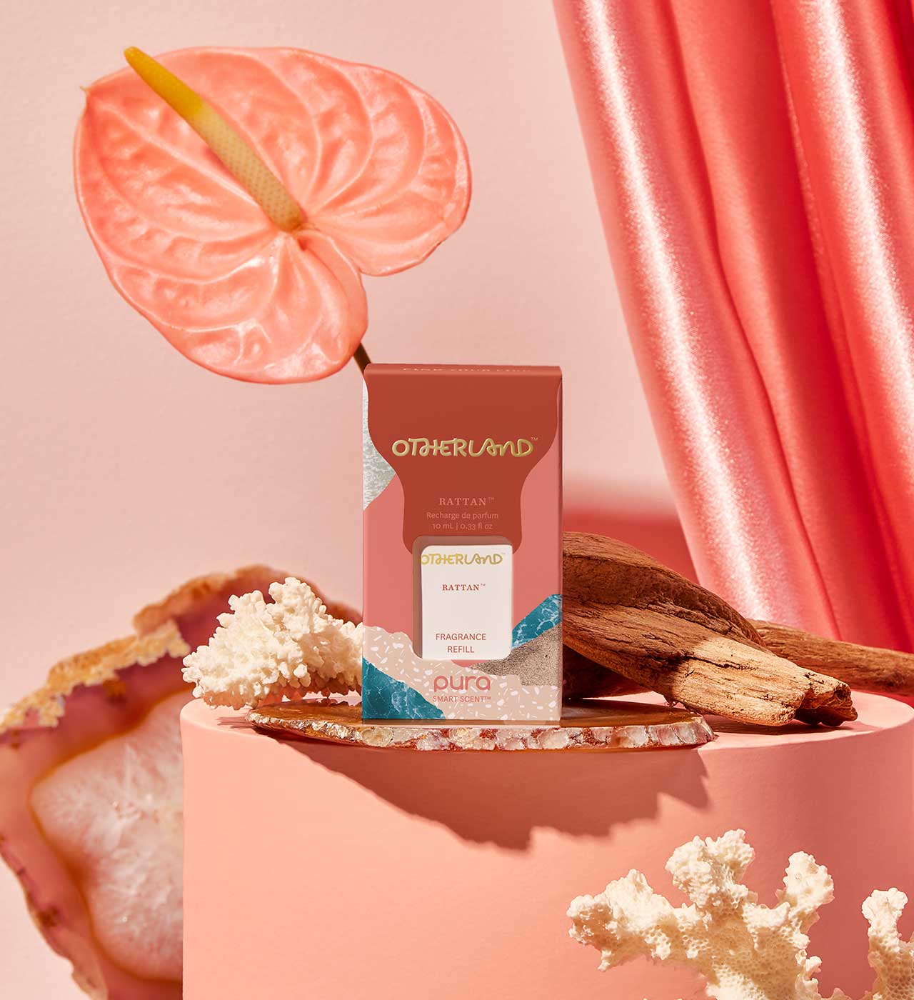 Otherland perfume bottle with pink anthurium flower and coral background